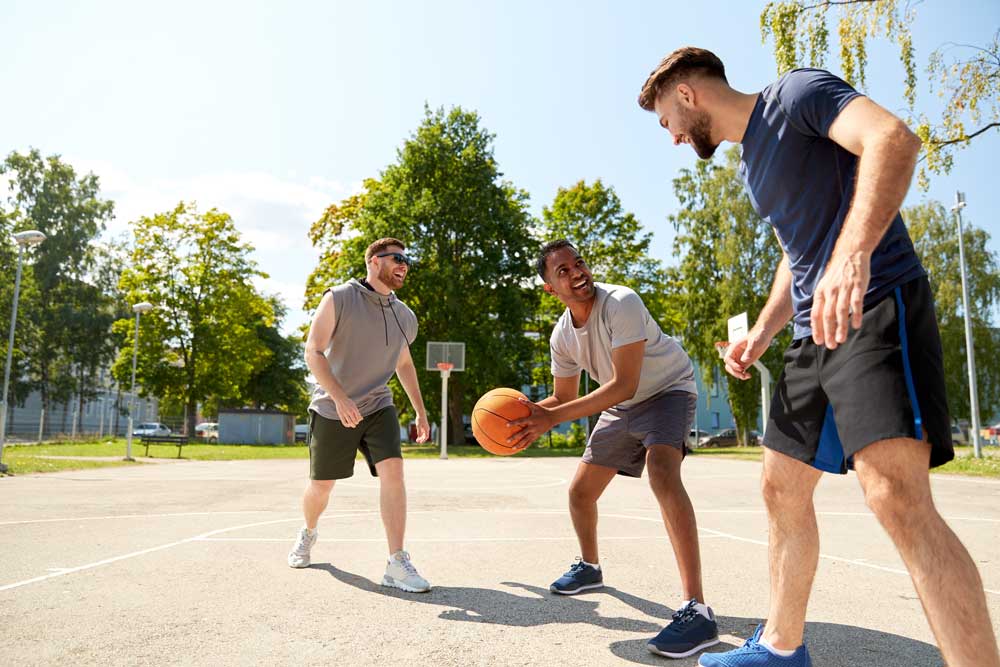 men playing basketball outside